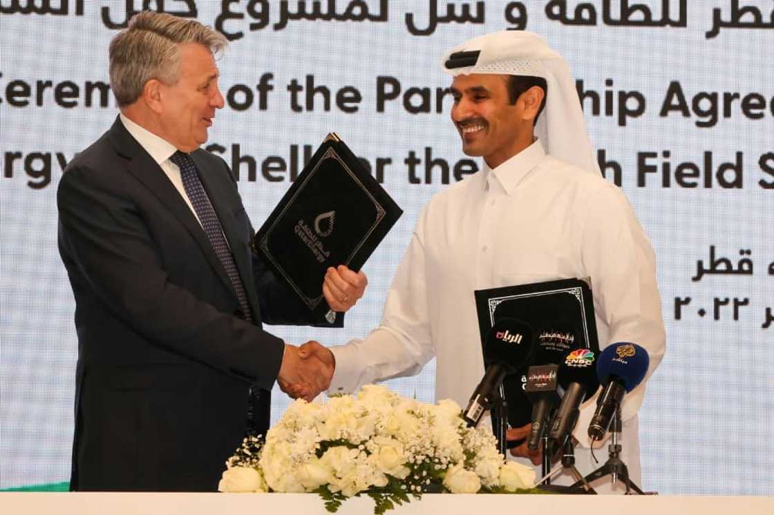 Qatar's Minister of State for Energy Affairs and President and CEO of QatarEnergy Saad Sherida al-Kaabi (R) and Shell’s CEO Ben van Beurden hold a signing ceremony at QatarEnergy headquarters in Doha, on October 23