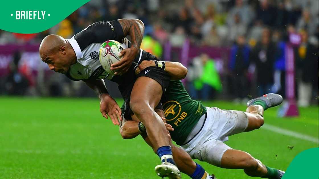Image showing Springboks player Cheslin Kolbe tackling Mark Telea of the Barbarians Image showing Springboks player Cheslin Kolbe tackling Mark Telea of the Barbarians