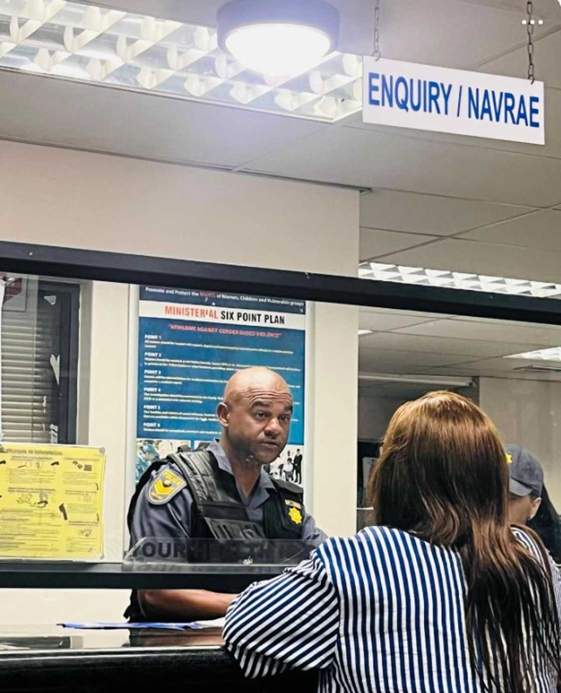 Sergeant Jacques Mannoe helping the woman who lost her phone. Sergeant Jacques Mannoe helping the woman who lost her phone.