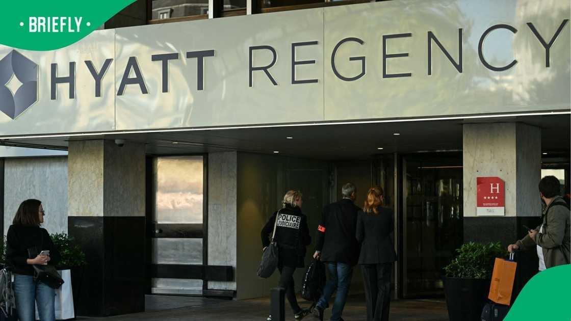 Members of the Judiciary Police stand outside the Hyatt Regency Paris Etoile Hotel where Nathi Mthethwa's body was found