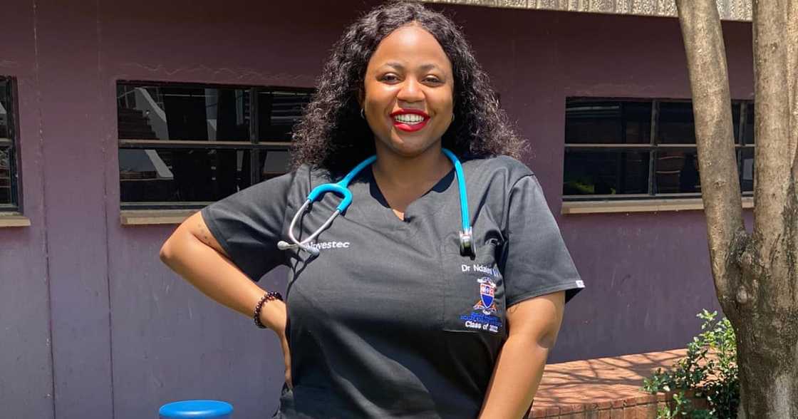 A young doctor in her scrubs with a stethoscope around her neck