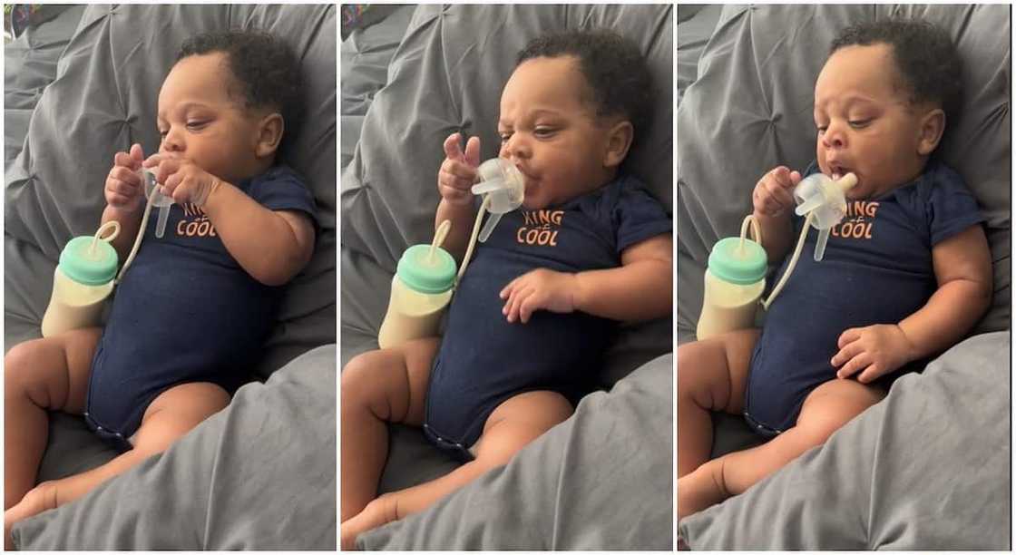 Photos of a little baby boy feeding himself with milk.