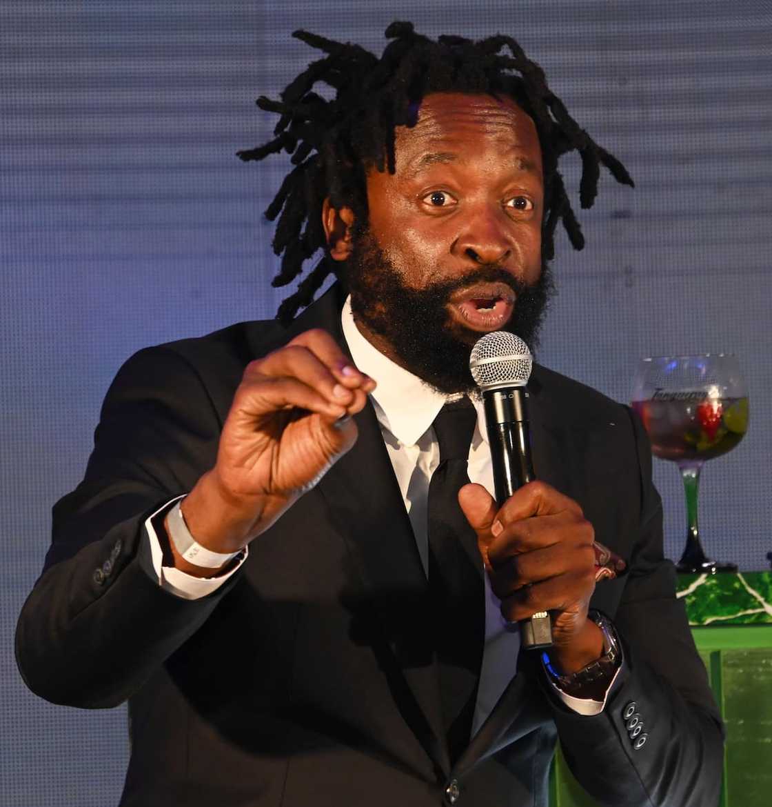 DJ Sbu speaking at an event DJ Sbu speaking at an event