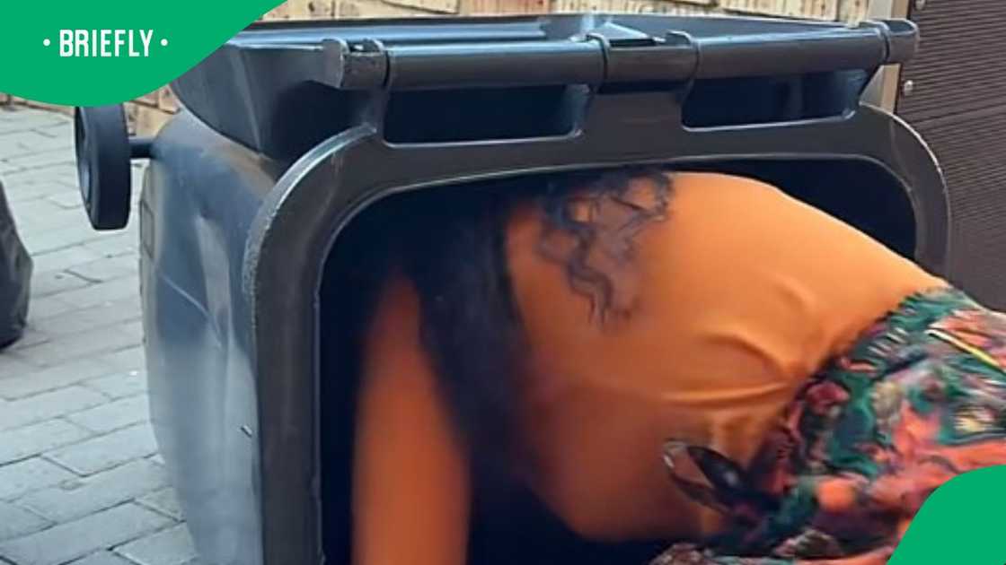 Woman enters bin to deep clean Woman enters bin to deep clean