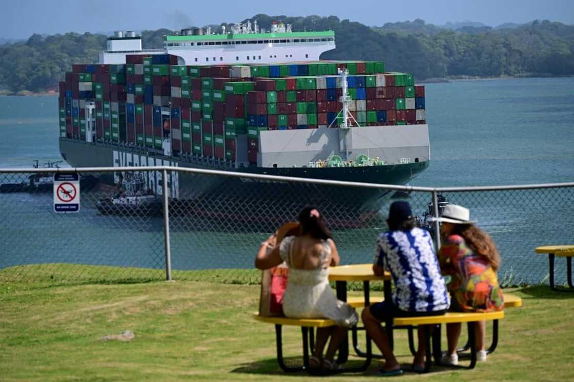 Tourists watch a cargo ship pass through the Panama Canal's Agua Clara Locks Tourists watch a cargo ship pass through the Panama Canal's Agua Clara Locks