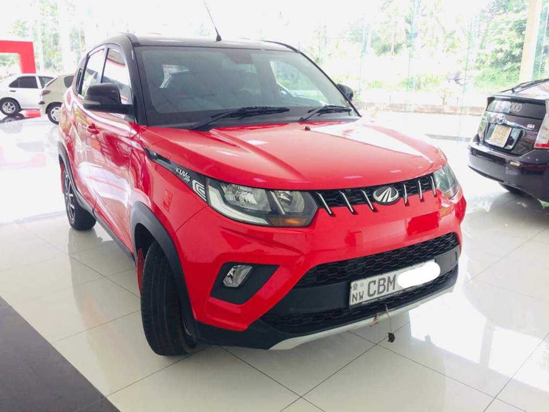 A red Mahindra KUV 100NXT in the yard A red Mahindra KUV 100NXT in the yard
