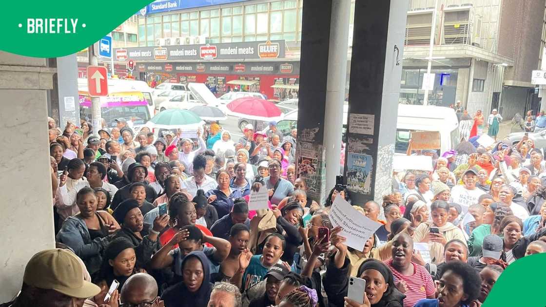 Durban residents protested after twins fell down a shaft, killing one of them Durban residents protested after twins fell down a shaft, killing one of them