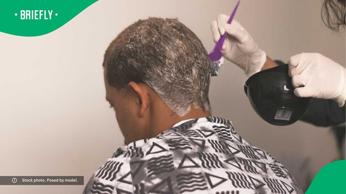 A person haivng their hair dyed. A person haivng their hair dyed.