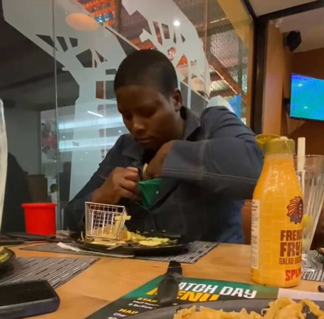 A woman in South Africa left Mzansi amused after being caught sneaking food into her top at a restaurant.