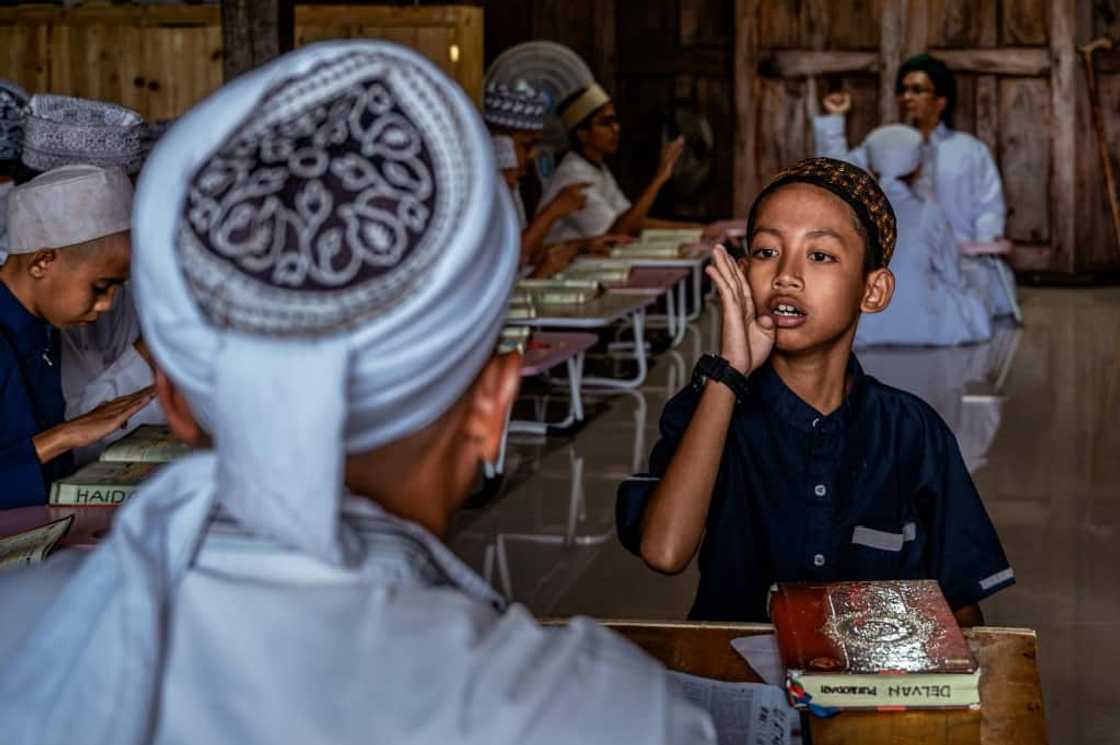 A student at the boarding school recites the Koran using sign language A student at the boarding school recites the Koran using sign language