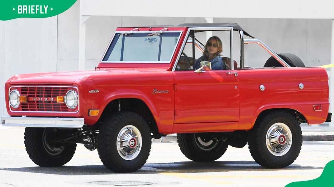 Actress Sydney Sweeney driving her Cherry red 1969 Ford Bronco in 2024