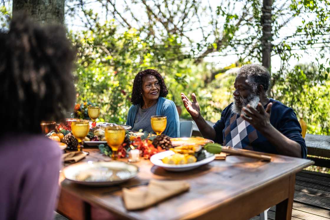 A man is giving a speech during family gathering A man is giving a speech during family gathering