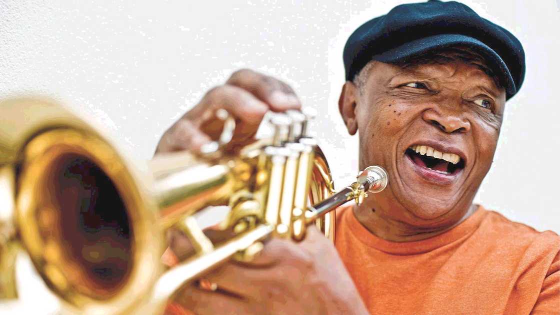 The late artist Hugh Masekela with a trumpet