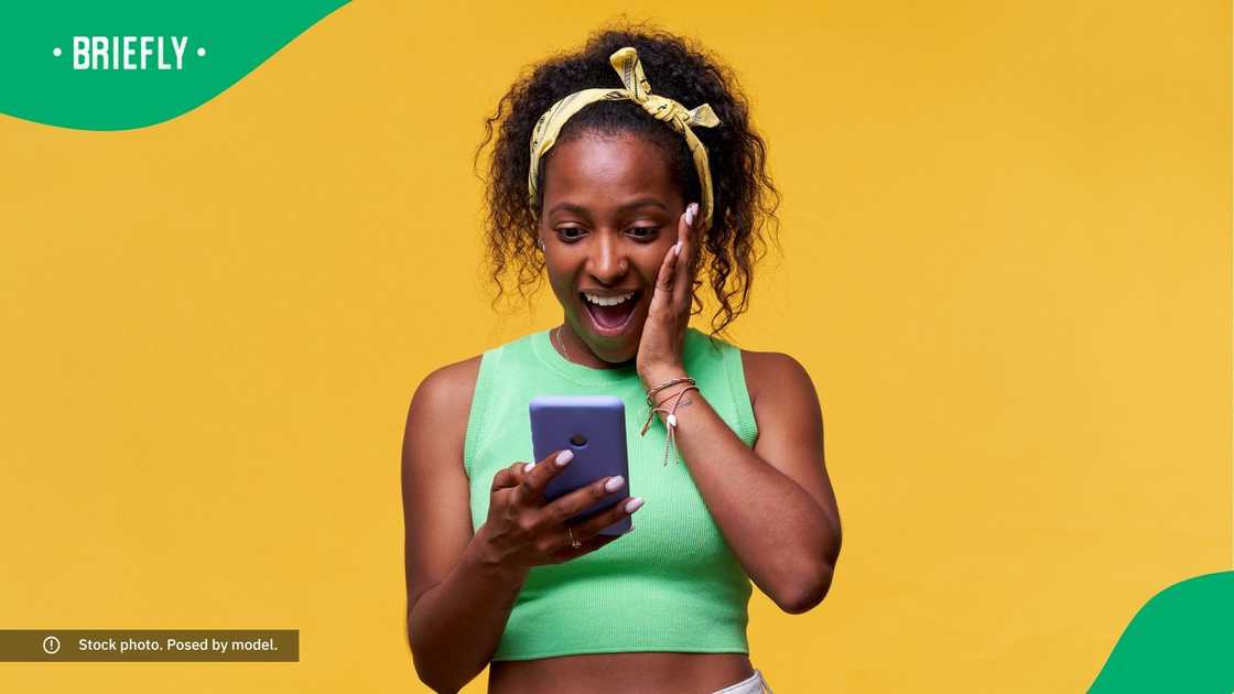 A surprised woman looking at her phone.