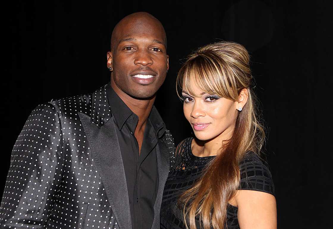Chad Ochocinco and Evelyn Lozada pose with Motorola Xoom at the Maxim Party Powered by Motorola Xoom at Centennial Hall at Fair Park on in February 2011 in Dallas, Texas