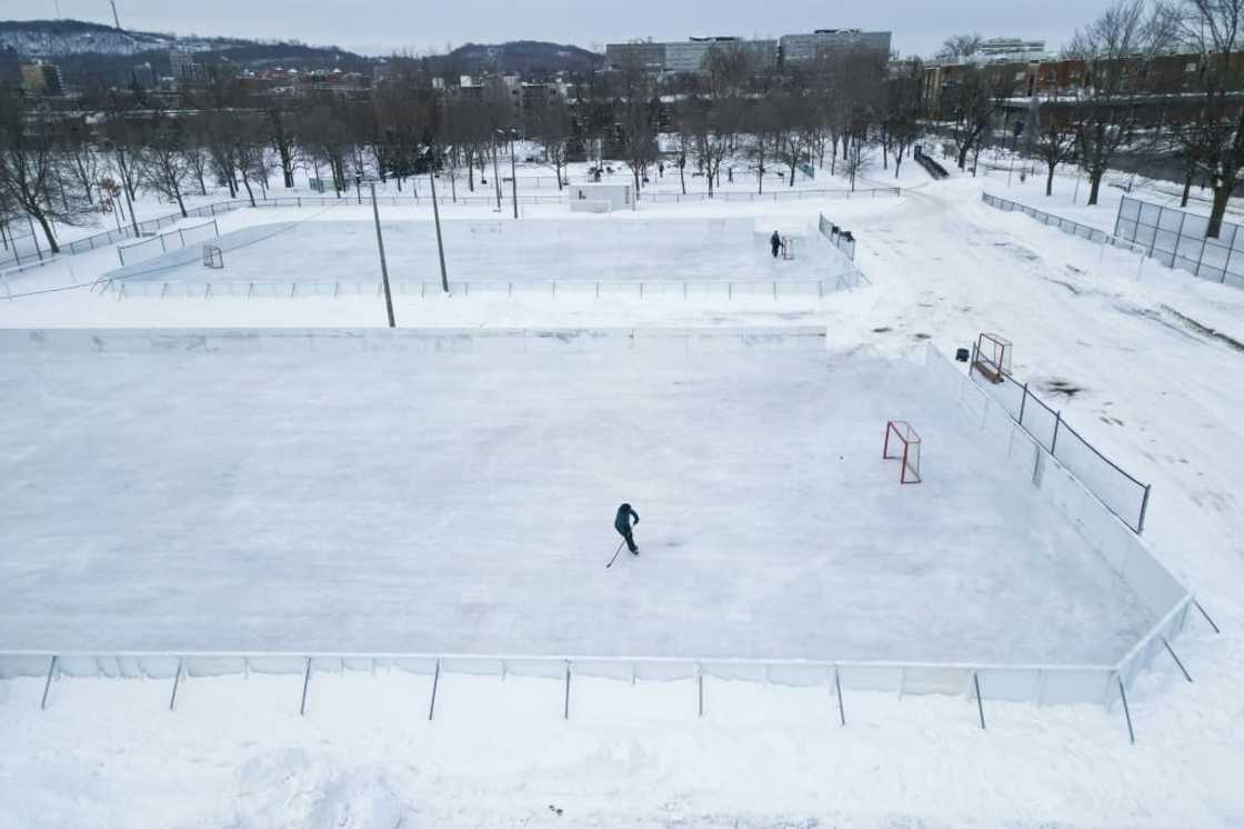A hockey player skates on one of the few open outdoor ice rinks at Laurier Park in Motnreal A hockey player skates on one of the few open outdoor ice rinks at Laurier Park in Motnreal