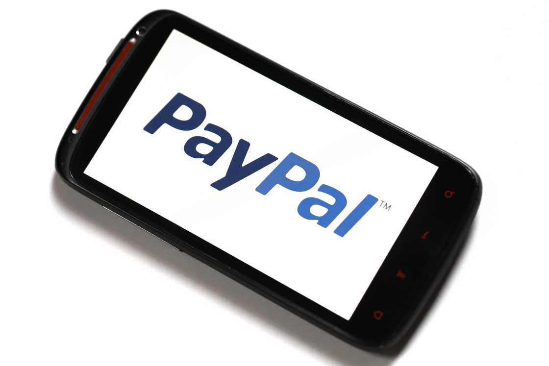 A smartphone with the PayPal logo displayed A smartphone with the PayPal logo displayed