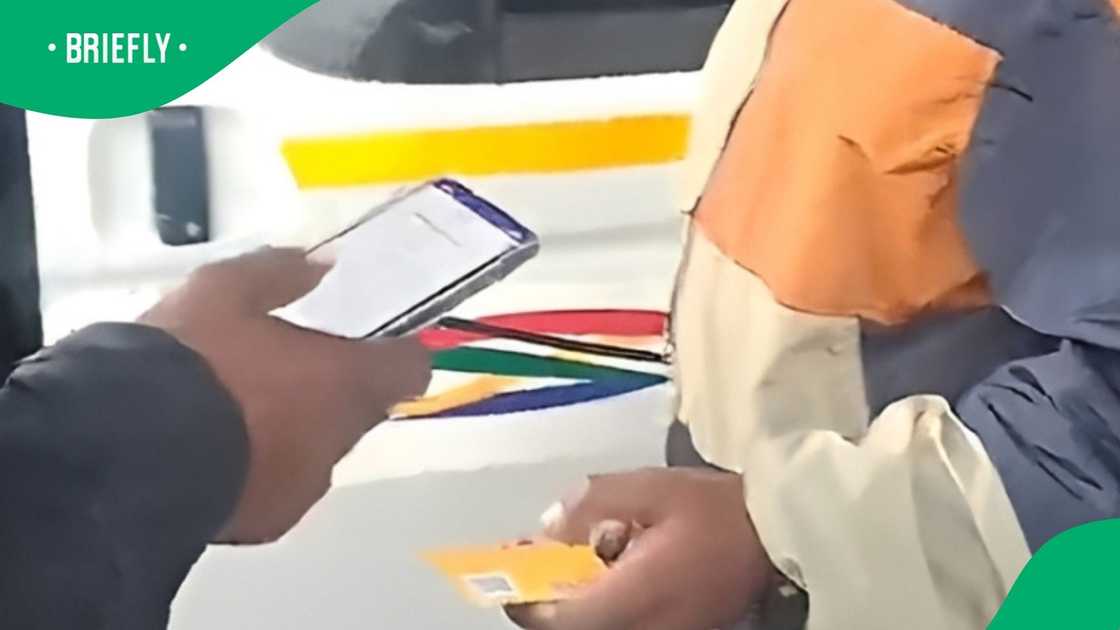 Card payment at taxi rank in video