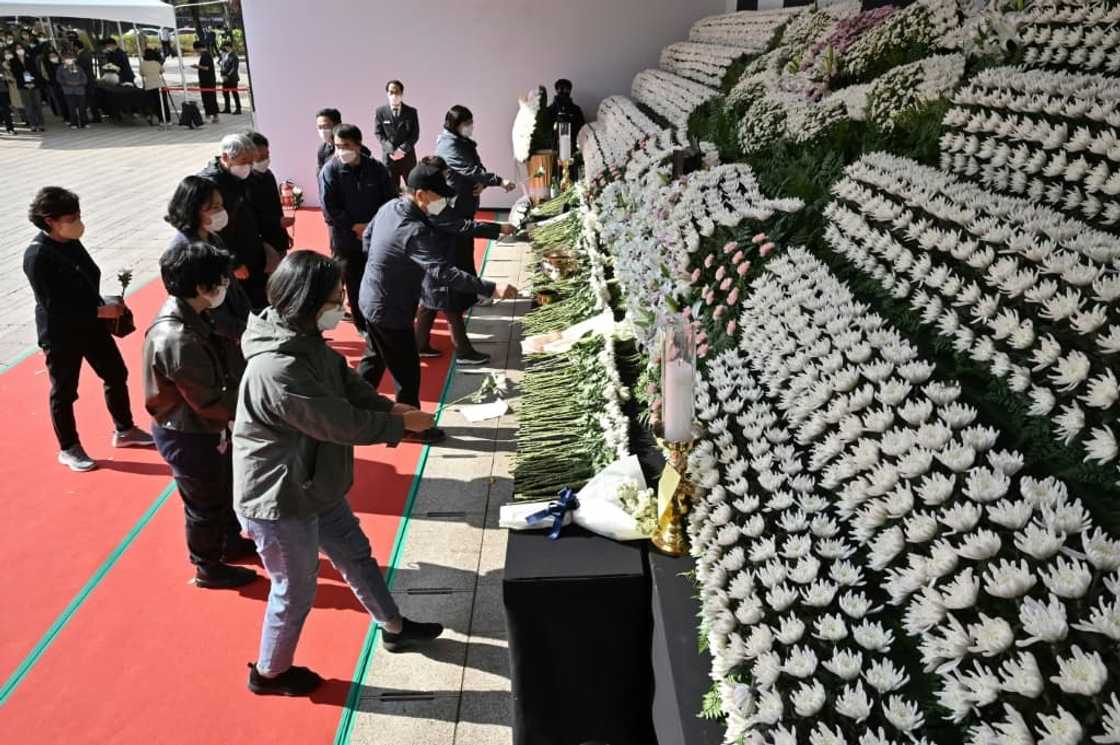 Mourners pay tribute in front of a joint memorial altar for victims of the deadly Halloween crowd surge in Seoul Mourners pay tribute in front of a joint memorial altar for victims of the deadly Halloween crowd surge in Seoul