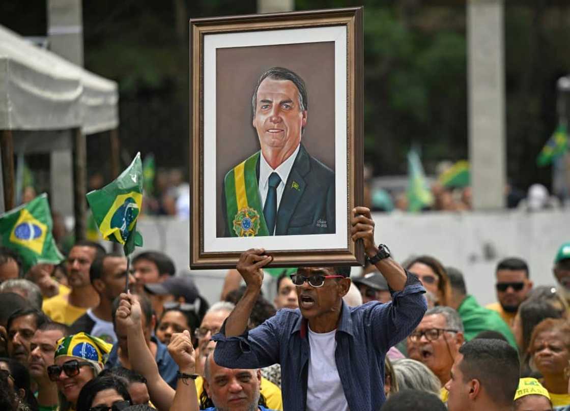 A supporter holds up a portrait of Brazil's far-right President Jair Bolsonaro at a rally A supporter holds up a portrait of Brazil's far-right President Jair Bolsonaro at a rally
