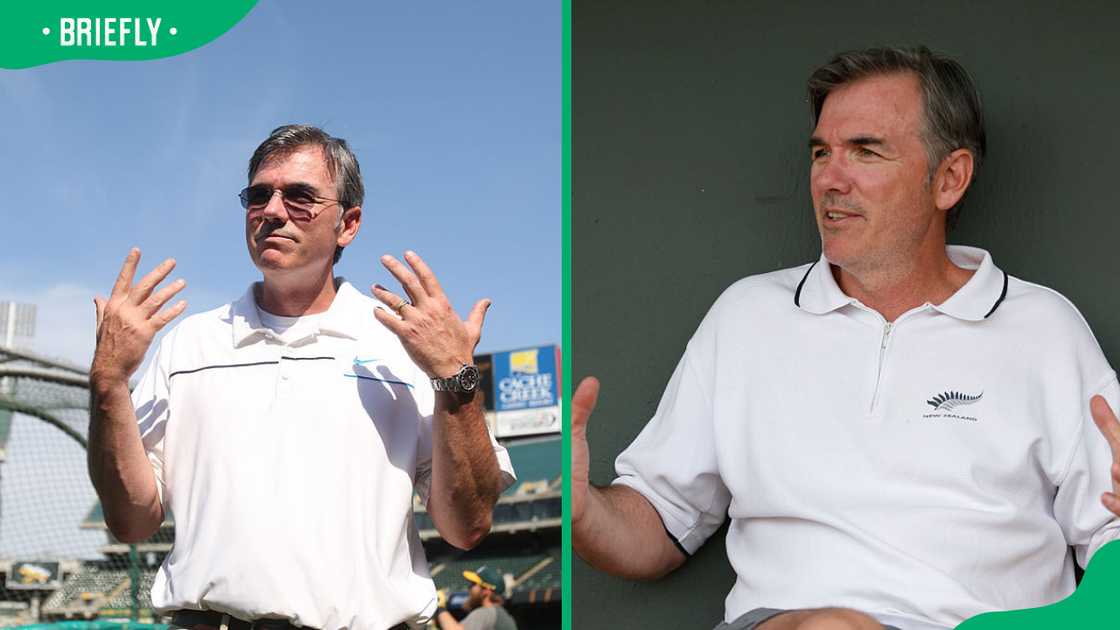 Billy Beane stands on the field prior to the game. Billy relaxes in the dugout prior to a spring training game.