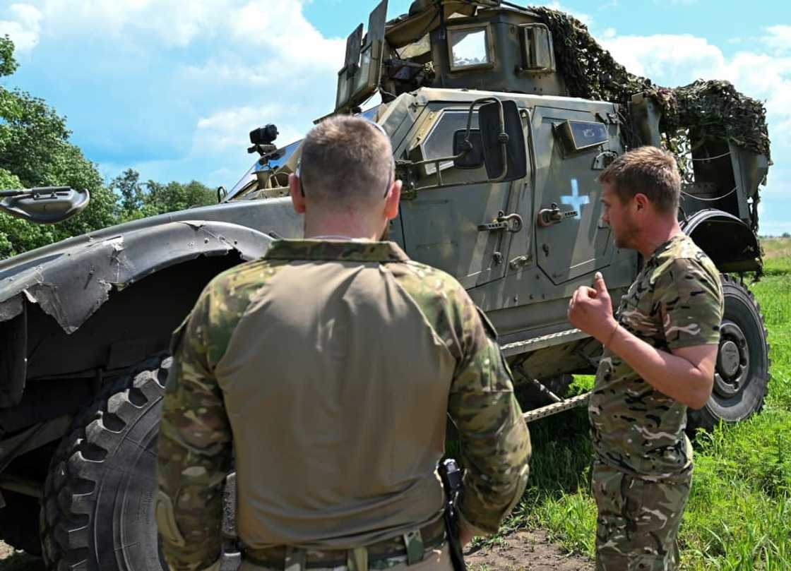 Ukrainian commander 'Spartanets' (L) said that the American Oshkosh vehicles were very good for protection