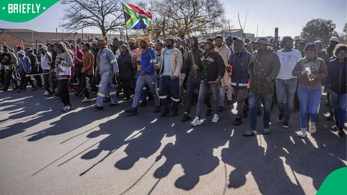 People gather to stage an anti-immigrant demonstration to call on the government to deport illegal immigrants