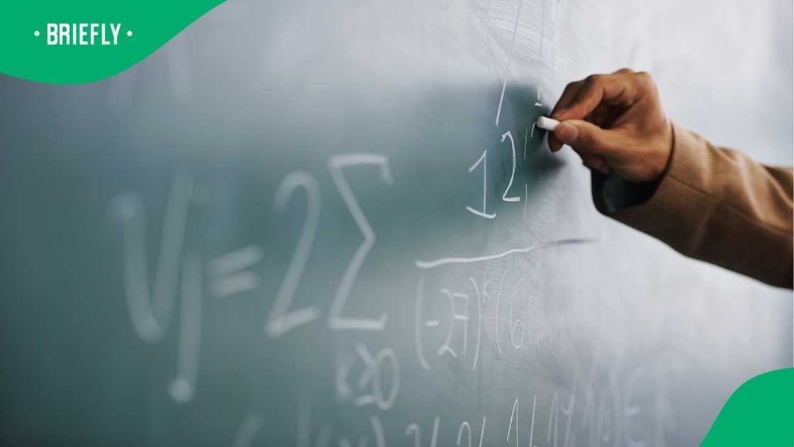 A teacher writes on a chalkboard in a classroom. As many as 2 400 teaching posts could be cut in the Western Cape if the Education Departments goes ahead with its plans.