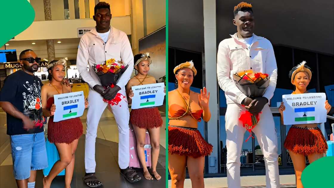 Traditional dancers and local hosts greeted the towering internet star with flowers and welcome signs outside the airport Traditional dancers and local hosts greeted the towering internet star with flowers and welcome signs outside the airport
