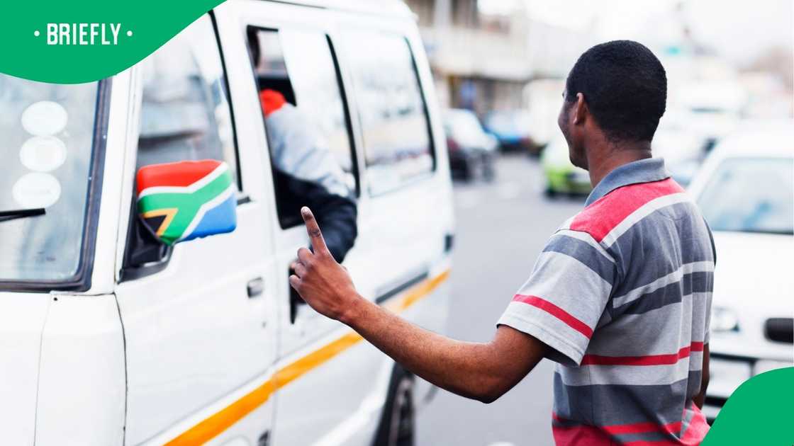 A stock photo of a man stopping a taxi