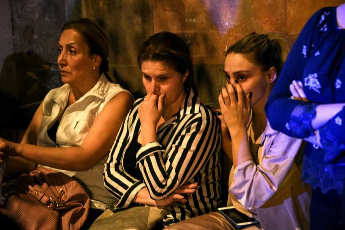 Relatives of servicemen who were wounded in border clashes between Armenia and Azerbaijan, gather anxiously outside a military hospital in Yerevan