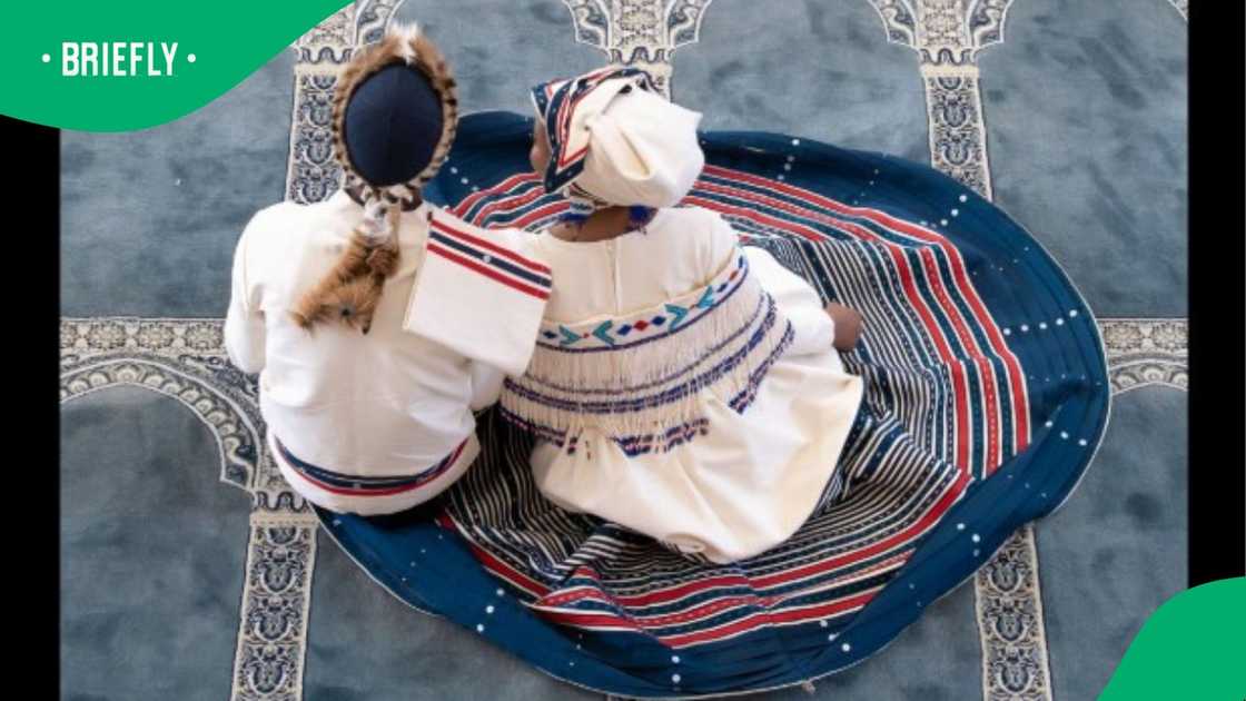 A Muslim couple sitting inside a mosque. A Muslim couple sitting inside a mosque.