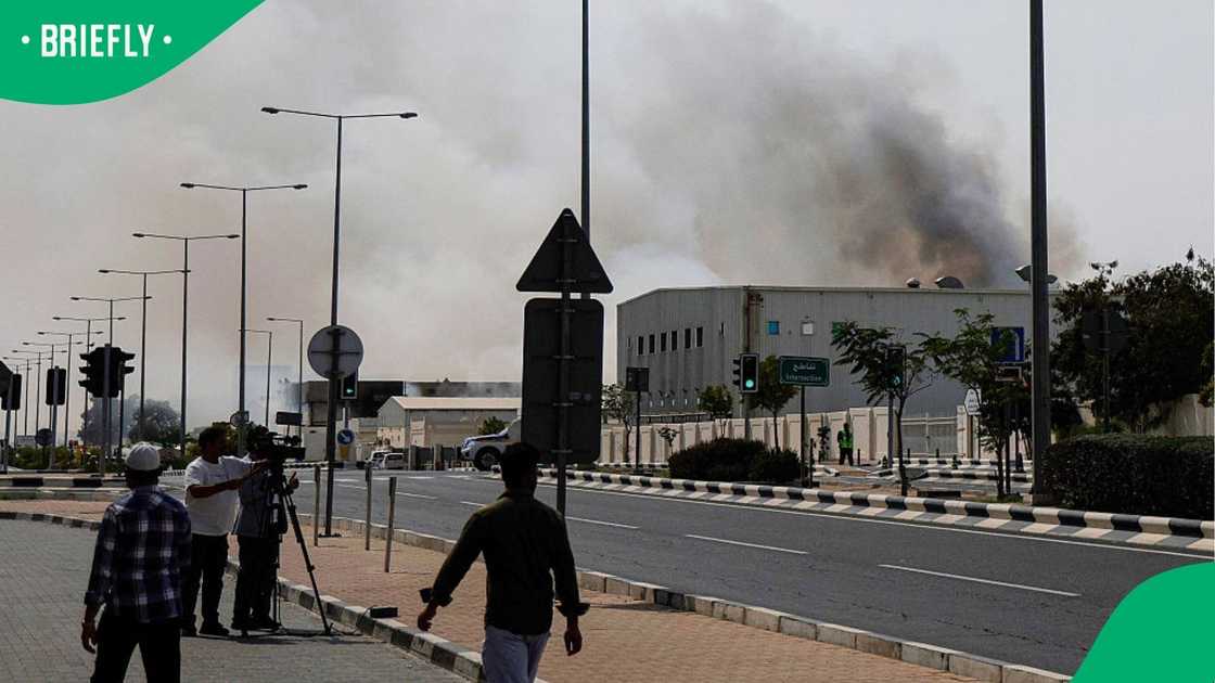 Media filming the rising smoke. Media filming the rising smoke.