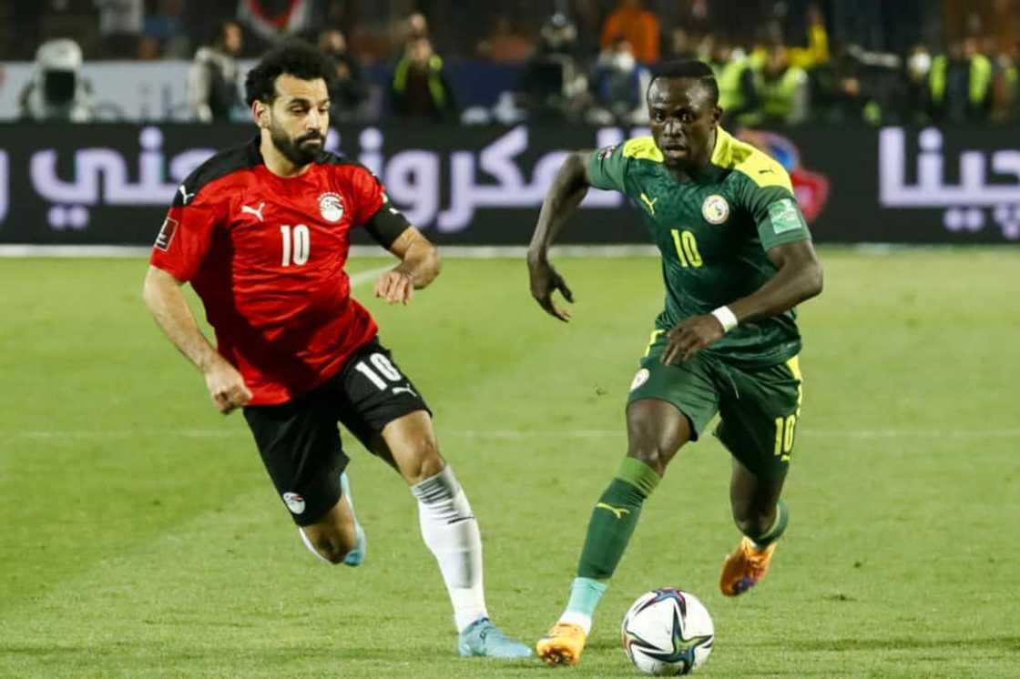 Egypt captain Mohamed Salah (L) chases Senegal star Sadio Mane (R) during a World Cup play-off in Cairo on March 25, 2022. Egypt captain Mohamed Salah (L) chases Senegal star Sadio Mane (R) during a World Cup play-off in Cairo on March 25, 2022.