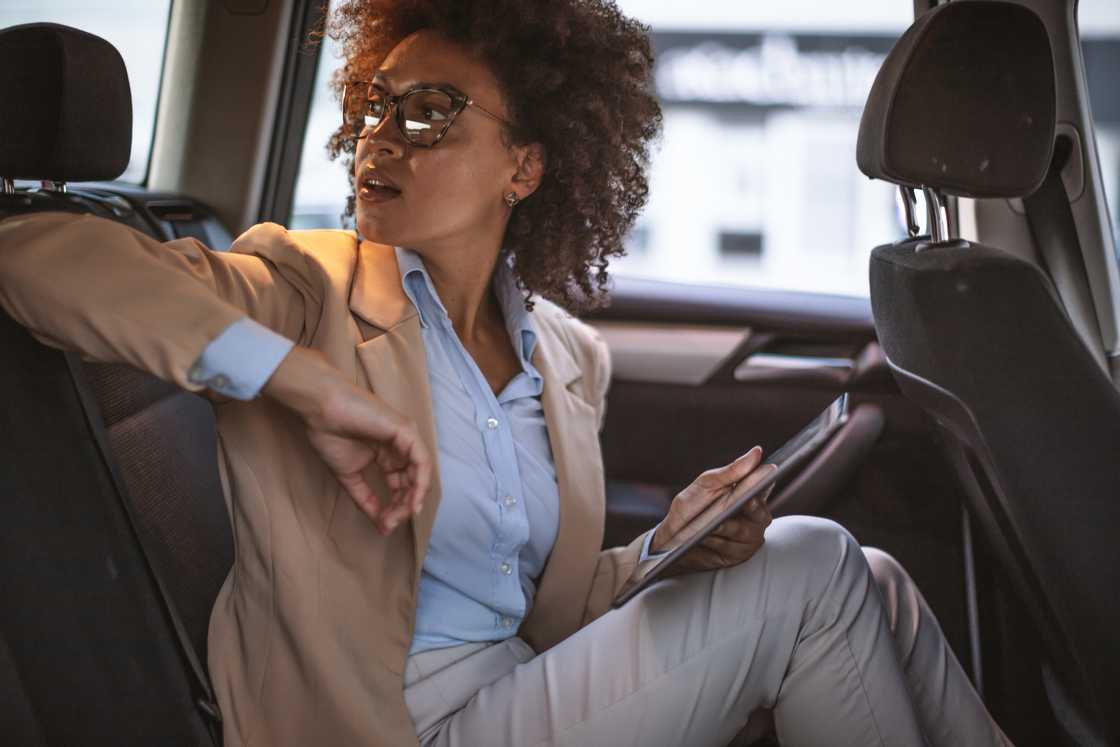 A frustrated passenger stick in traffic, checking the time.
