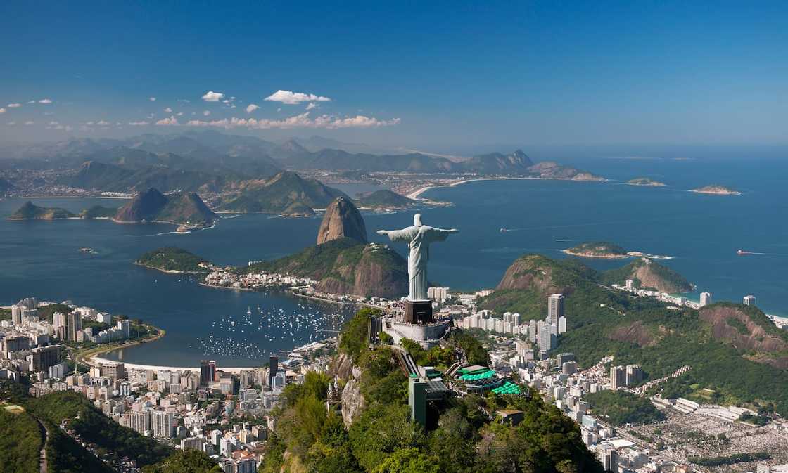 Aerial view of the 'Christ The Redeemer' statue, with Sugarloaf Mountain and Botafogo Beach in the background. Aerial view of the 'Christ The Redeemer' statue, with Sugarloaf Mountain and Botafogo Beach in the background.