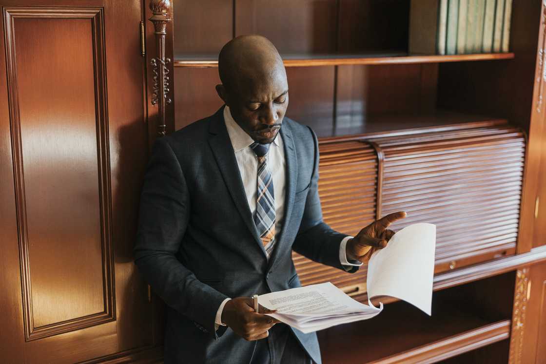 A lawyer reads the will to the benefactors. A lawyer reads the will to the benefactors.