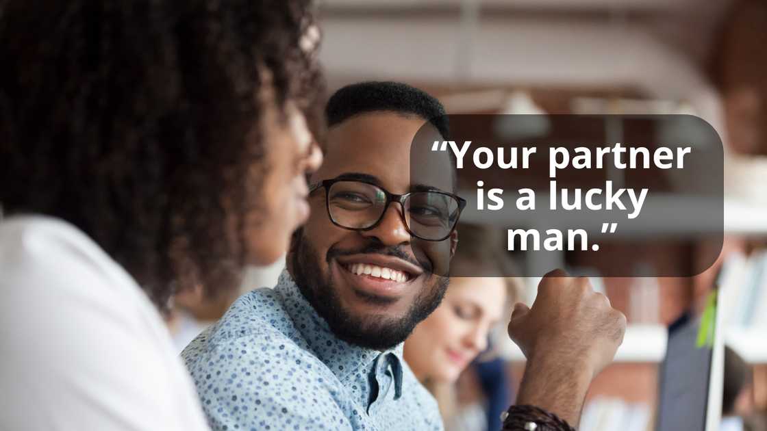 A manager looking at female colleague chatting in office