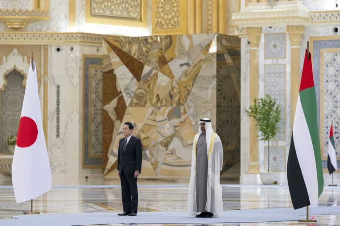 UAE President Sheikh Mohammed bin Zayed Al Nahyan (R) welcoming Japan's Prime Minister Fumio Kishida