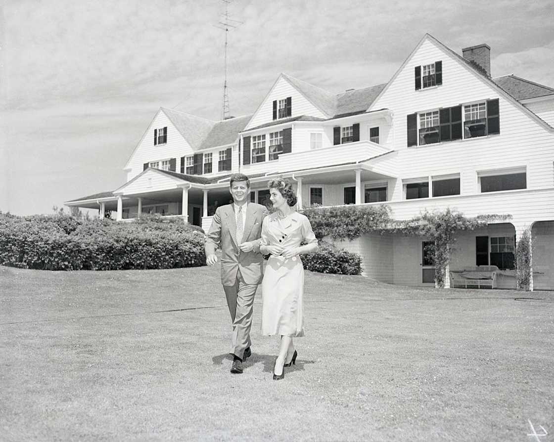 Senator John F. Kennedy and Miss Jacqueline Bouvier stroll across a lawn Senator John F. Kennedy and Miss Jacqueline Bouvier stroll across a lawn