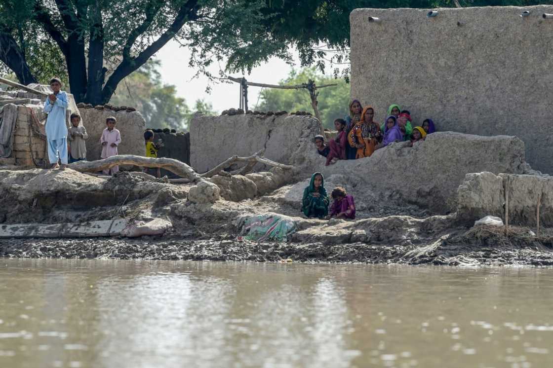 Many people are stranded in isolated hamlets above a landscape of water in the south and west