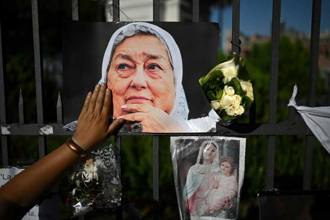 A woman touches a picture of the late Hebe de Bonafini during a ceremony at the Plaza de Mayo in Buenos Aires on November 24, 2022 A woman touches a picture of the late Hebe de Bonafini during a ceremony at the Plaza de Mayo in Buenos Aires on November 24, 2022