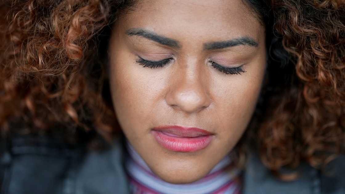 A woman closing eyes in contemplation