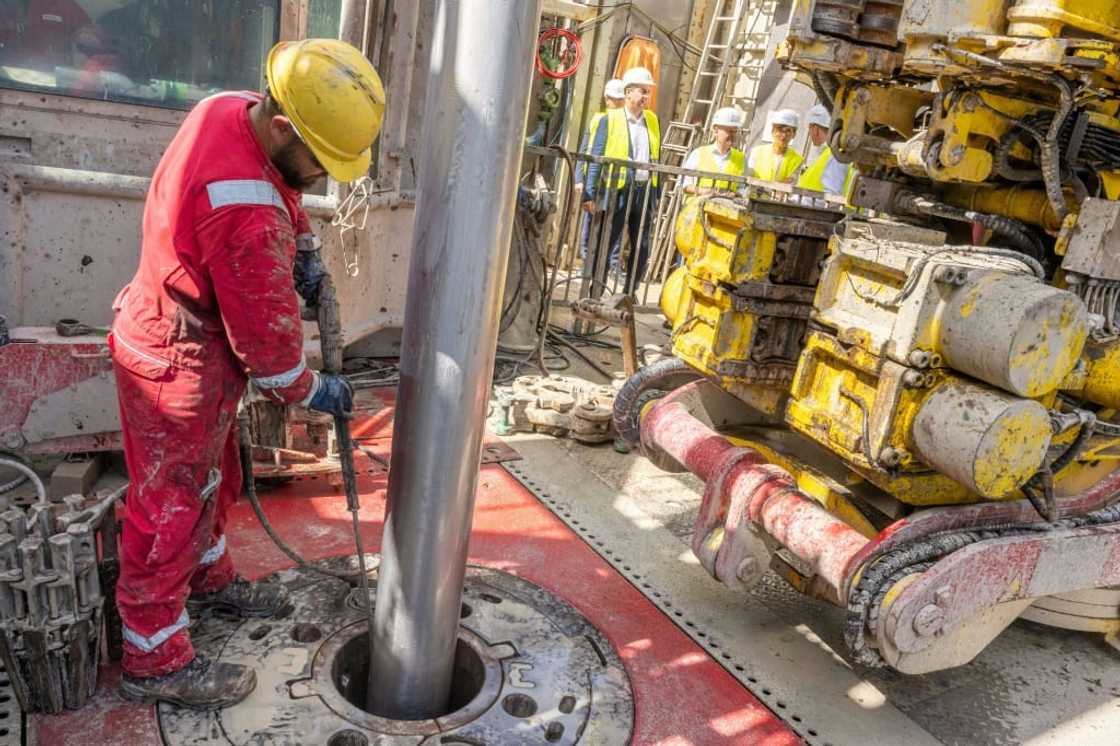 A worker operates a drill at a geothermal plant construction site in south Germany