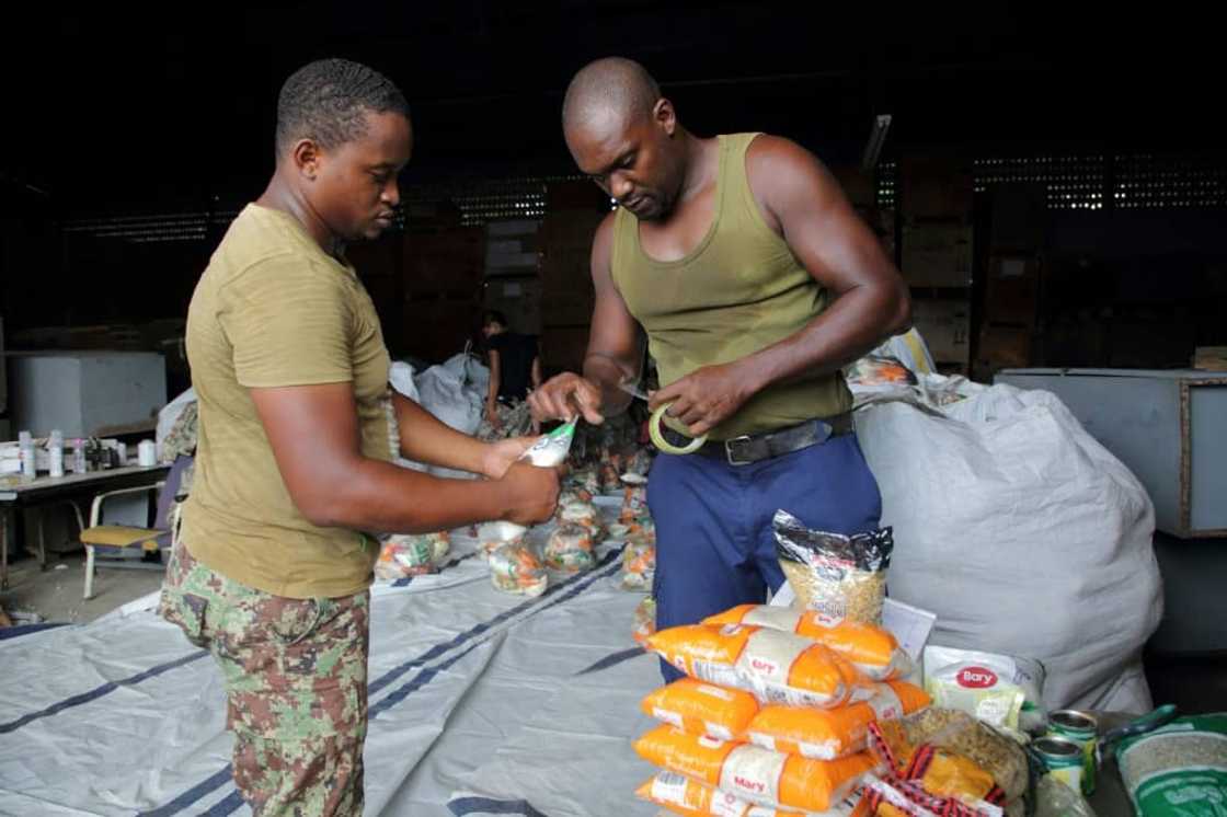 Soldiers pack food supplies after receiving a 40,000 tons of aid from Venezuela