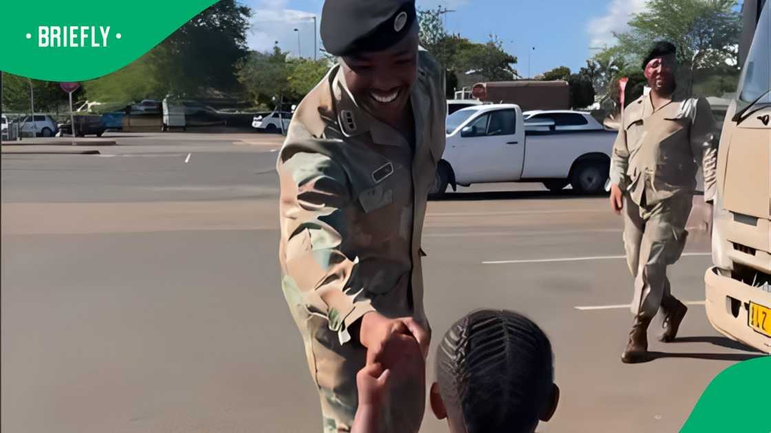 A child greets soldiers