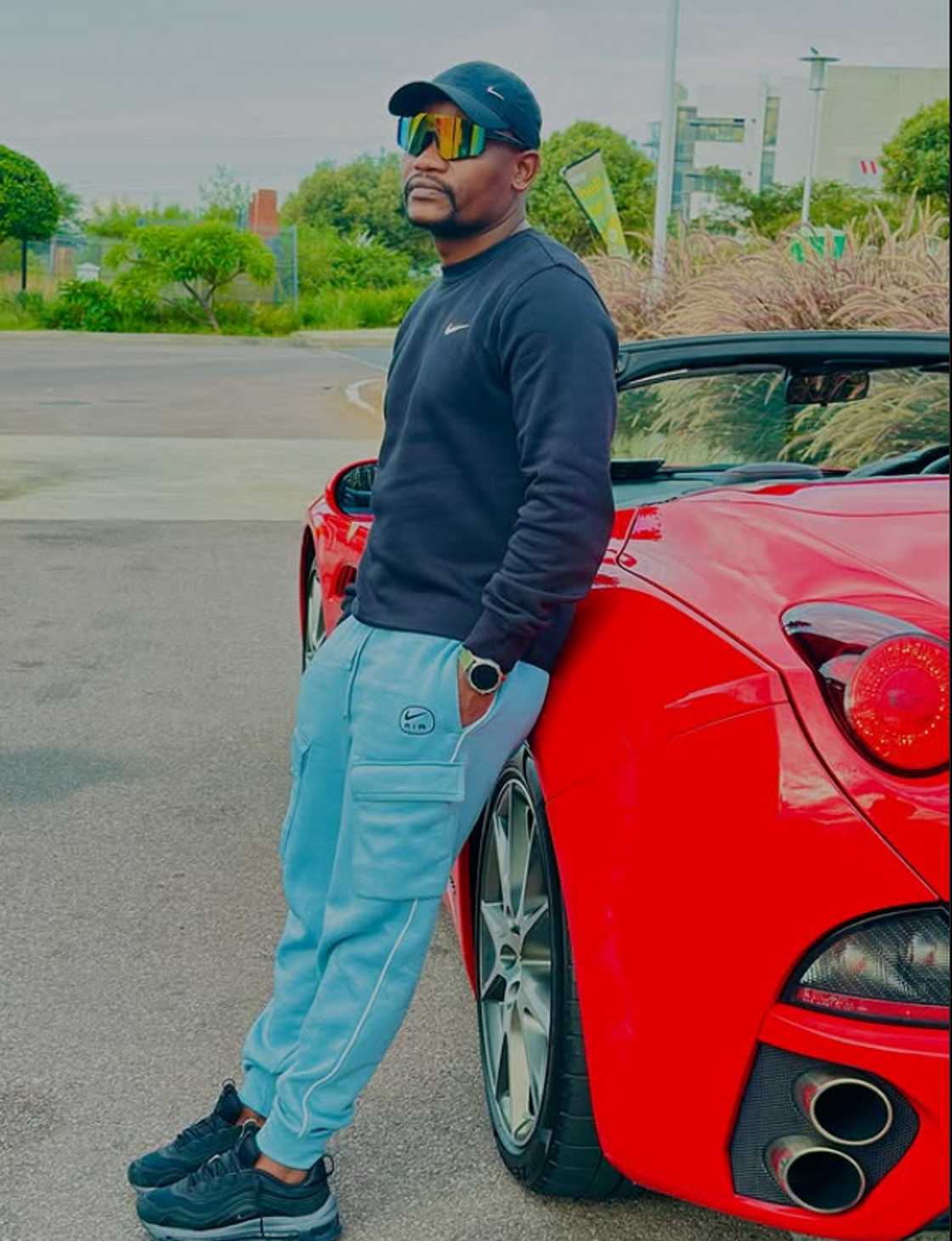 Clement Maosa showed off his red Ferrari. Clement Maosa showed off his red Ferrari.