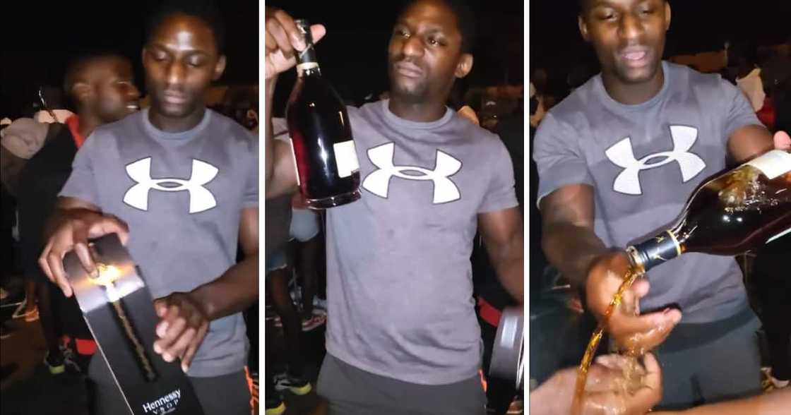 A man flexed with an expensive bottle of Hennessy. A man flexed with an expensive bottle of Hennessy.