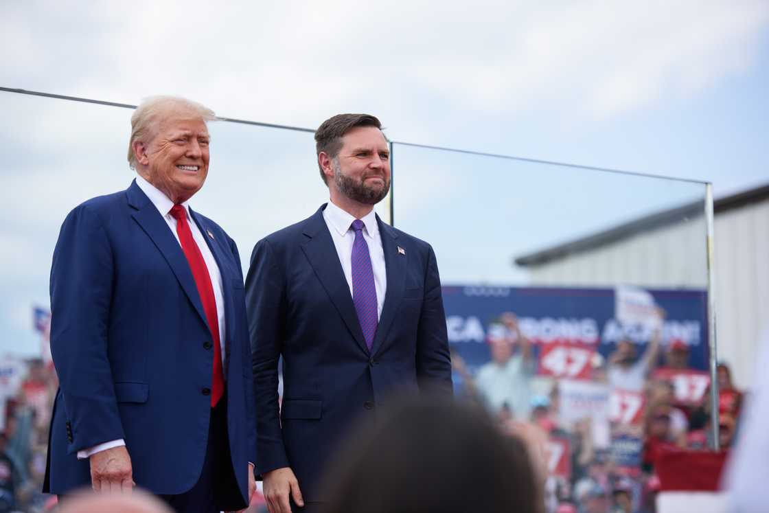 Donald Trump poses for photos with J.D. Vance before making remarks to a crowd during an event in Asheboro, North Carolina