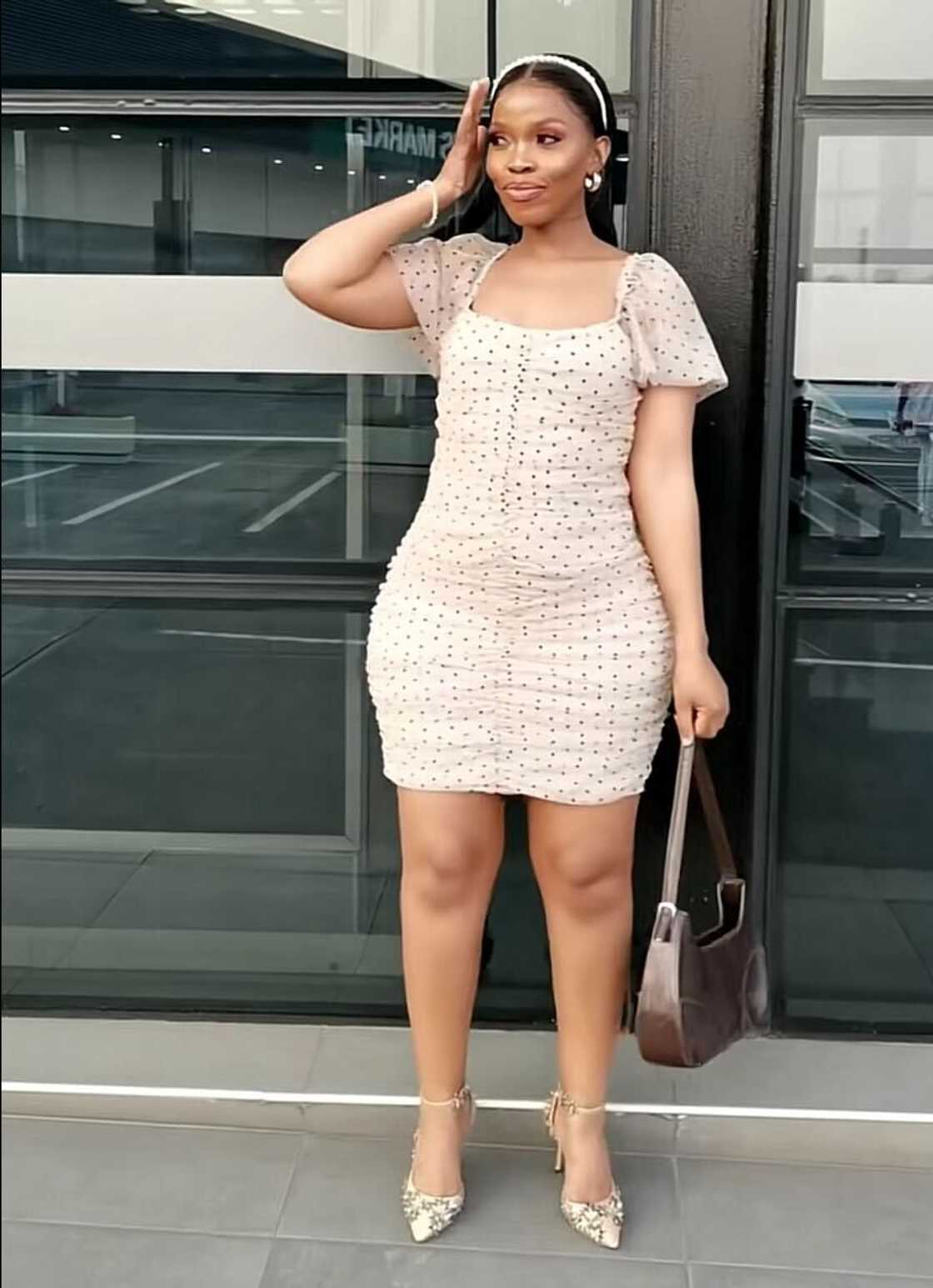 A woman in South Africa posed in a cute summer dress paired with stunning high heels. A woman in South Africa posed in a cute summer dress paired with stunning high heels.